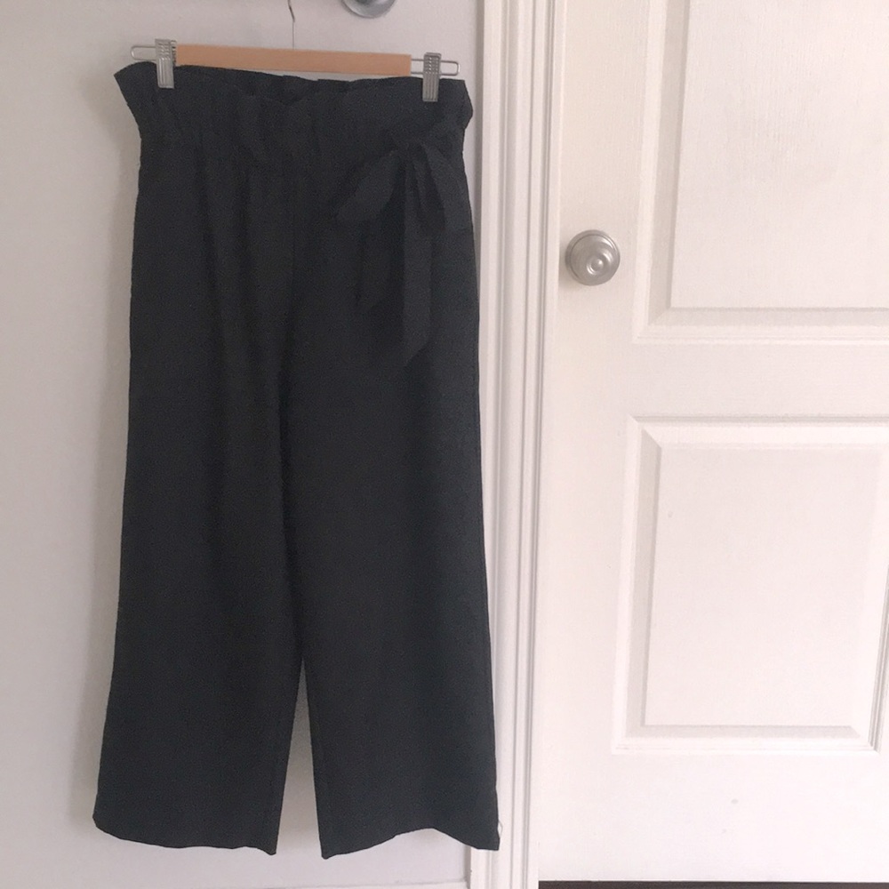 Black wide pants, paper bag waist.